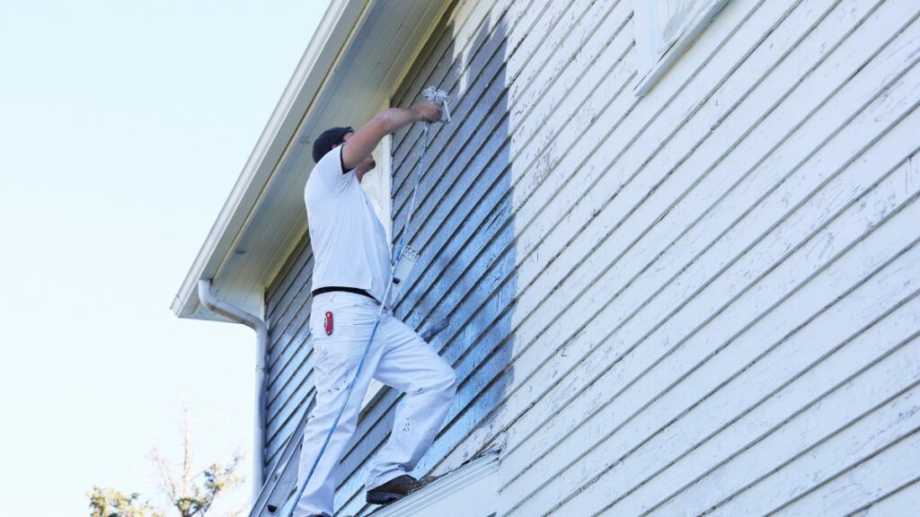professional painter using a paint sprayer