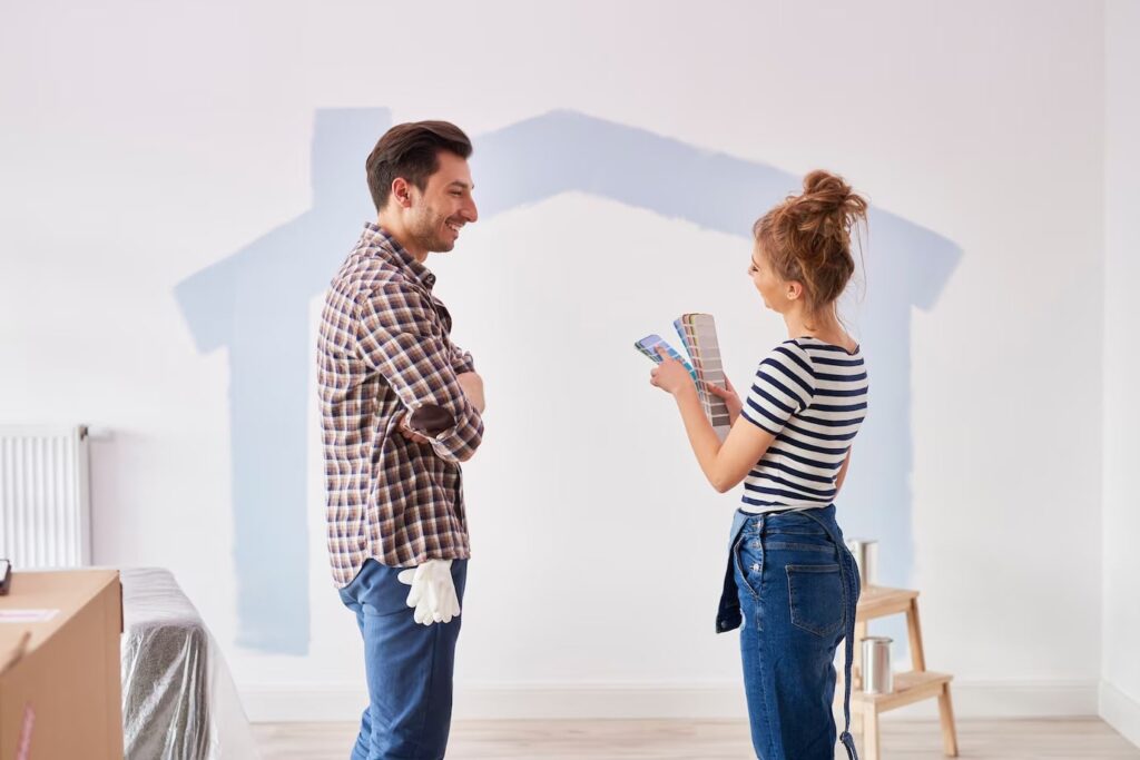 Couple Painting Interior Wall on their New Apartment