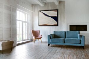 Interior design with photoframes and a blue couch