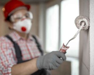 Female Construction-Worker with Helmet Paint Roller