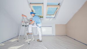 a professional painter standing on a stepladder