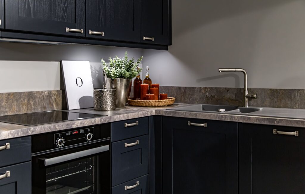Dark kitchen cabinets with metal pulls or knobs in home interior