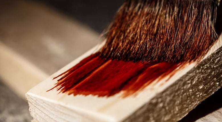 A Paint Brush with a Dark Red color Paint