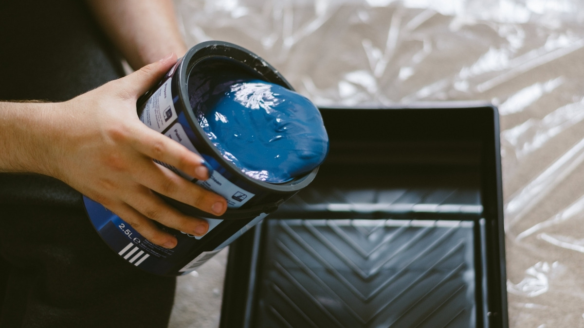 pouring thick, dark blue paint